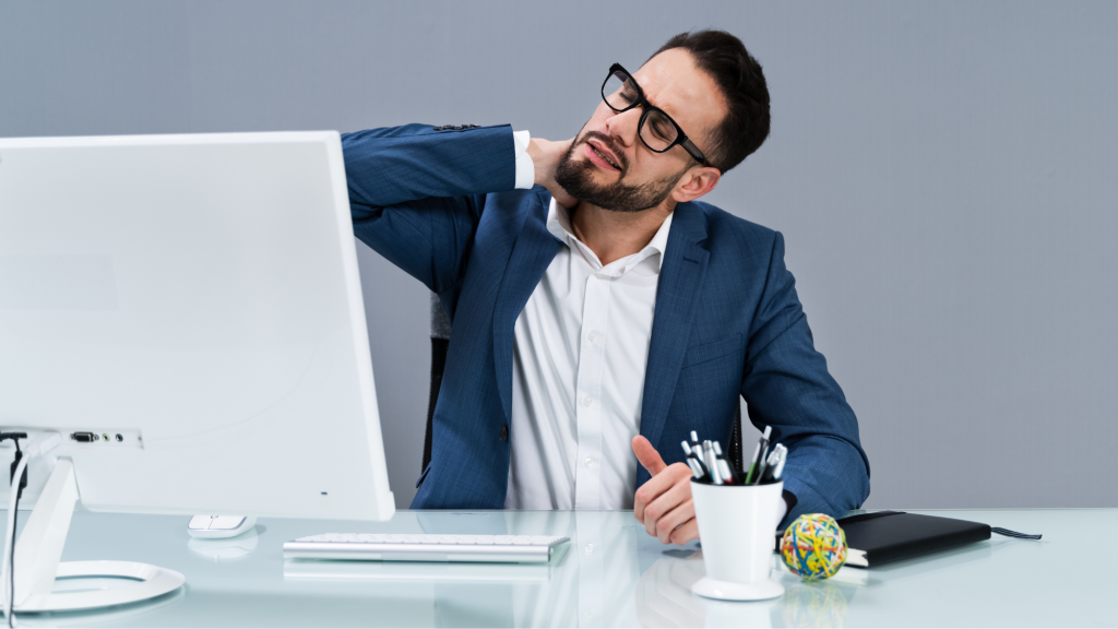 man stretching at his desk based on kaizo health's top 5 desk exercises