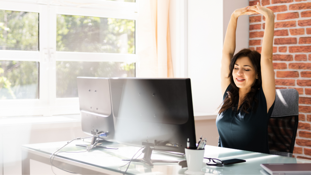 woman stretching at her desk using top chiropractor recommended stretches 