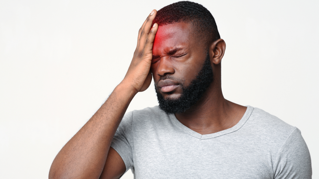 man suffering from concussion symptoms getting chiropractic care after being cleared for treatment
