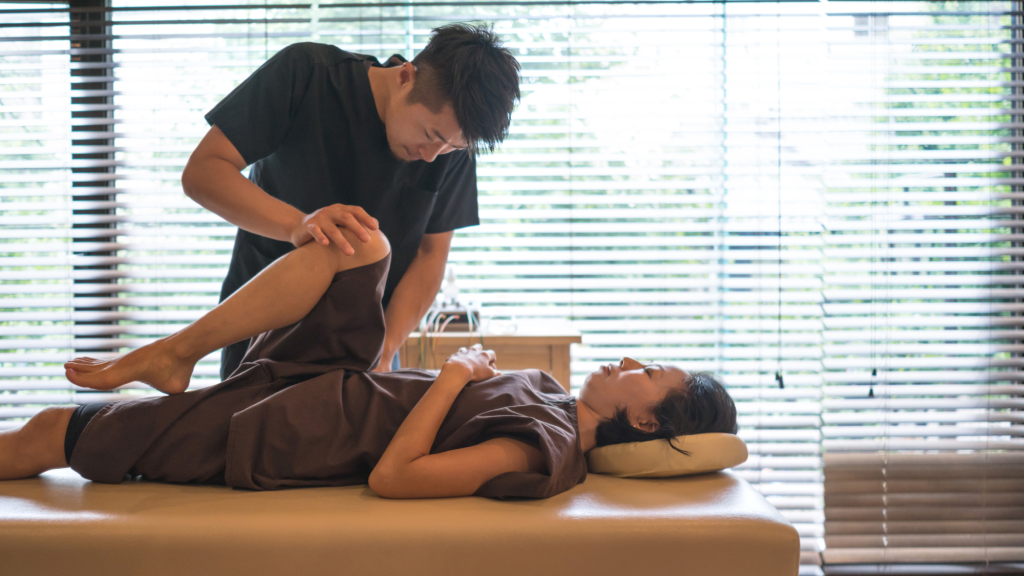 chiropractor doing a treatment to help woman with scoliosis pain