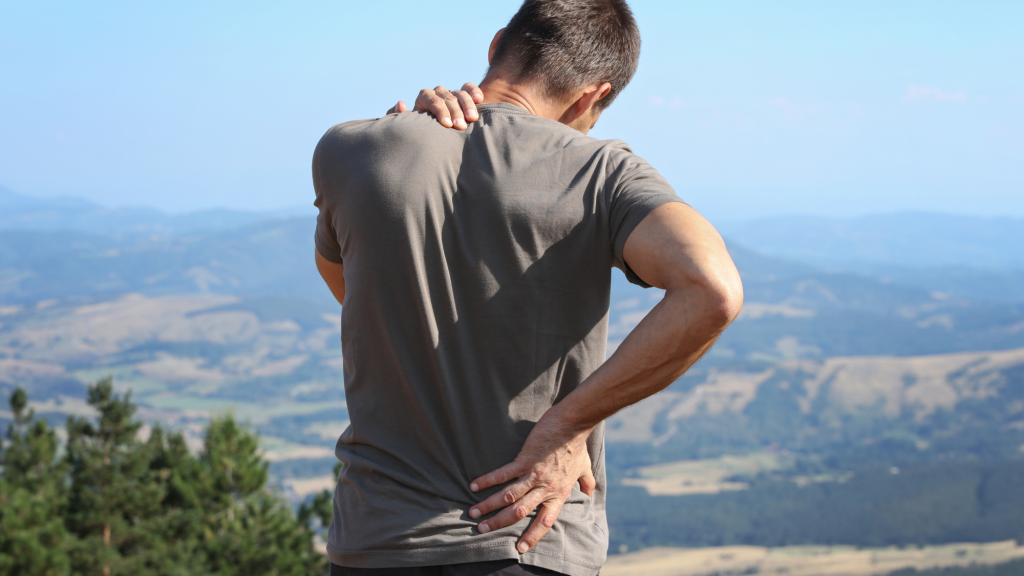 man showing back pain from chiropractic care