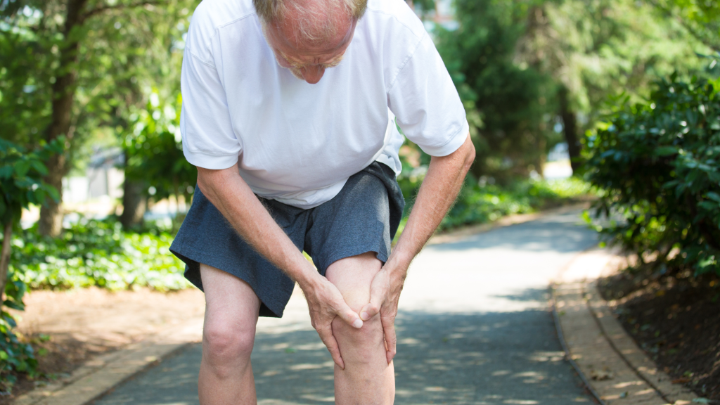 man holding right knee after hurting acl