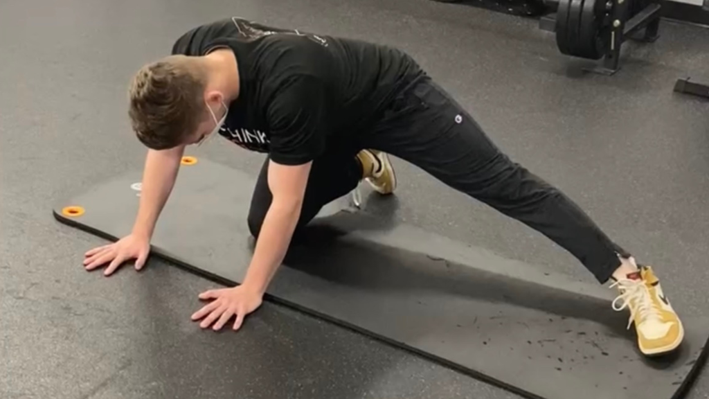 patient utilizing leg stretch that chiropractor provided him