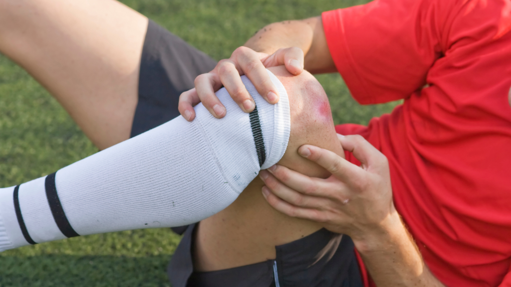 soccer player holding his left knee after getting an mcl injury