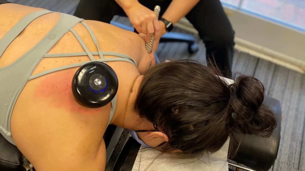 chiropractor using IASTM on patient 