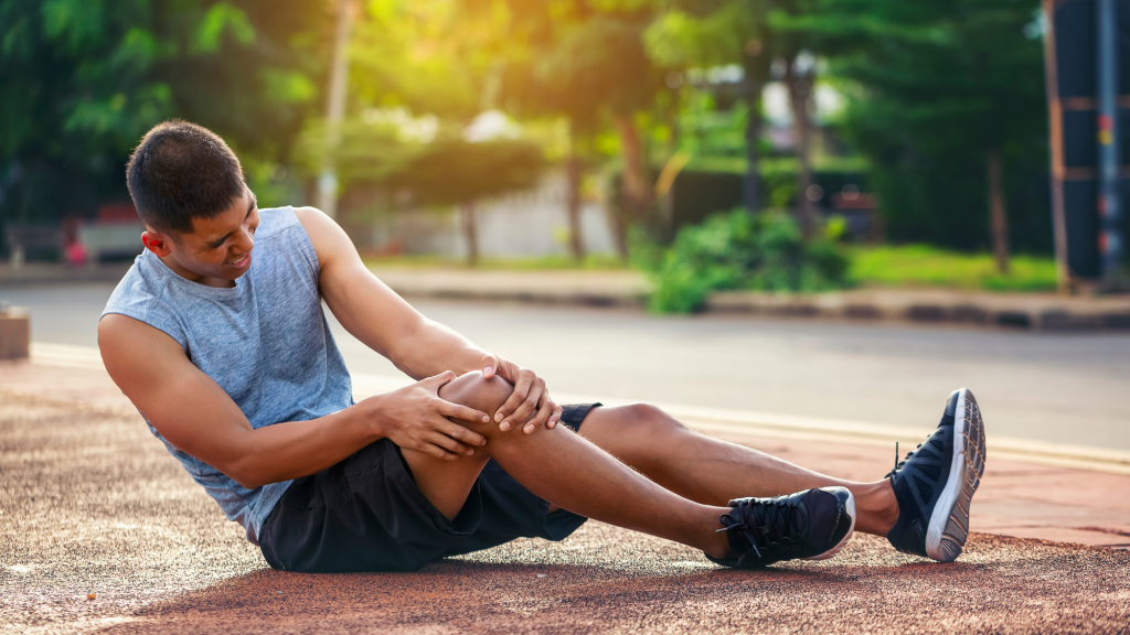 man holding right knee for ACL tear 